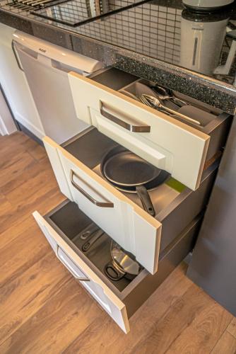 an open kitchen drawer with a stove in it at Camyuva Beach Hotel in Kemer