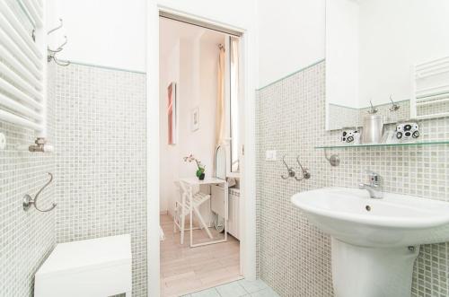 a white bathroom with a sink and a toilet at My Bed Vatican Museum in Rome