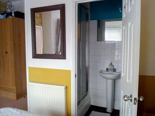 a bathroom with a sink and a mirror at Seamore Guest House in Great Yarmouth