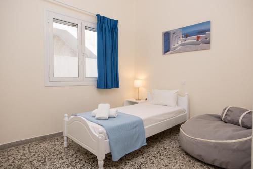 a bedroom with a bed and a chair and a window at Spacious apartment on the beachfront in Melission