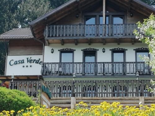 a wooden house with a balcony and flowers at Casa Verde in Voronet