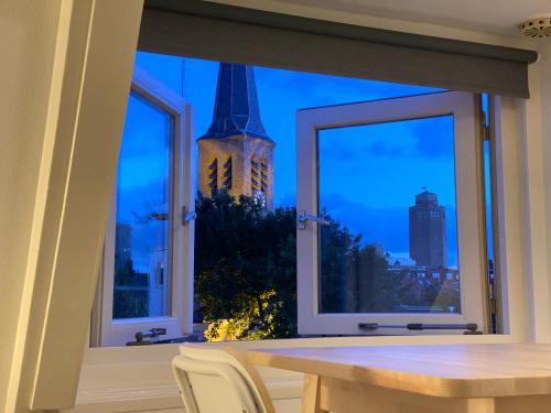 a window with a view of the eiffel tower at Church Square Studio in Zandvoort