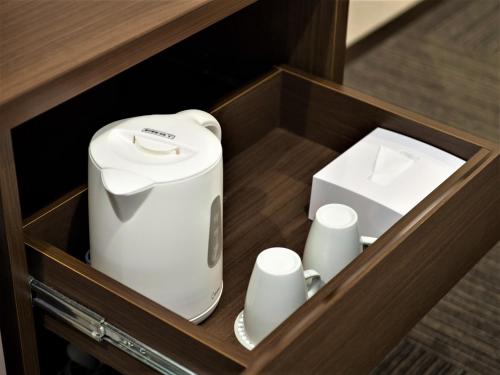 a toaster and a box in a wooden drawer at SHIN YOKOHAMA SK HOTEL - Non Smoking - Vacation STAY 86111 in Yokohama