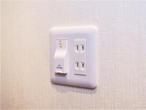 a white light switch on a wall at SHIN YOKOHAMA SK HOTEL - Non Smoking - Vacation STAY 86110 in Yokohama