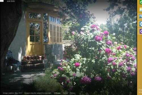 a bunch of flowers in front of a house at Mountain Refuge Guest House in Baltit