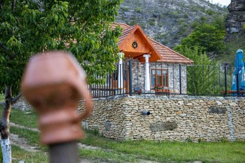 a small house on top of a stone wall at Casa Agricultorului Varzari in Butuceni
