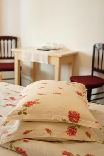 a pillow sitting on top of a bed with a table at Casa Ciortea Ana in Sibiel