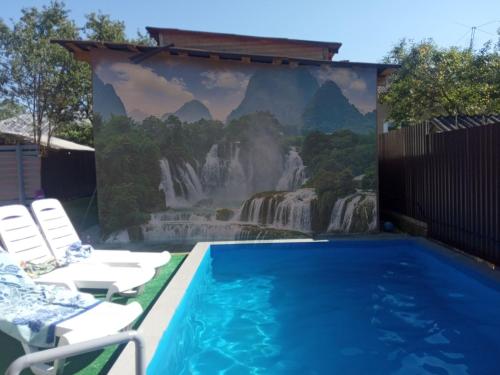 a mural of a waterfall and a swimming pool at Prykarpatska Villa in Morshin
