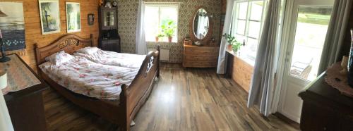 Schlafzimmer mit einem Bett und einem Spiegel in der Unterkunft Berget in Skillingaryd