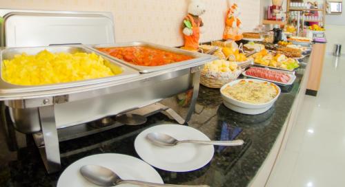 a kitchen counter filled with lots of different types of food at Villarejo Parque Hotel in Penha