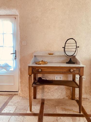a wooden table in a room next to a door at LE DOMAINE DE COAT ROGAN, La chambre du Tregor in Ploëzal