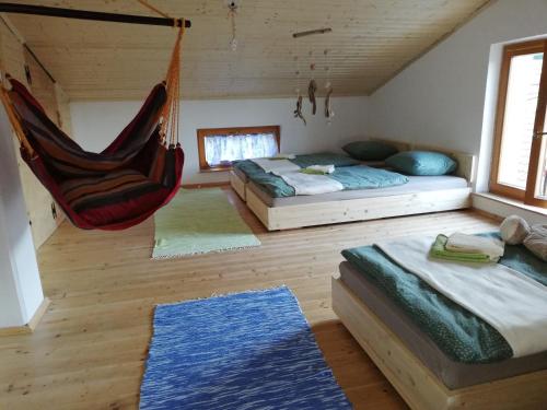 a room with two beds and a hammock at Seventh house in Ilirska Bistrica