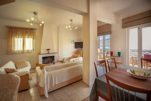 a living room with a couch and a fireplace at MisterCrete Holidays House in Milatos