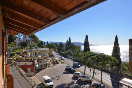 a view of a street with cars parked on the road at Taverna Affittacamere in Gardone Riviera