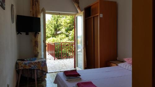 a room with two beds and a sliding glass door at Apartment Katica in Crikvenica