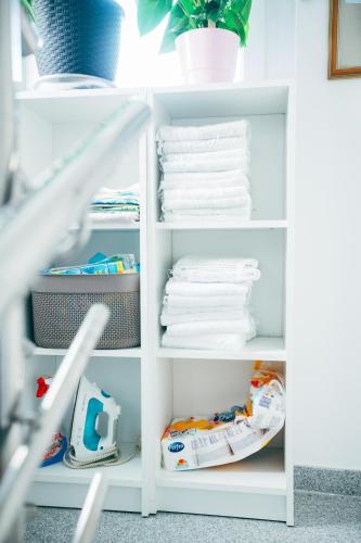 a white refrigerator filled with lots of towels at Apartment Zore in Promajna