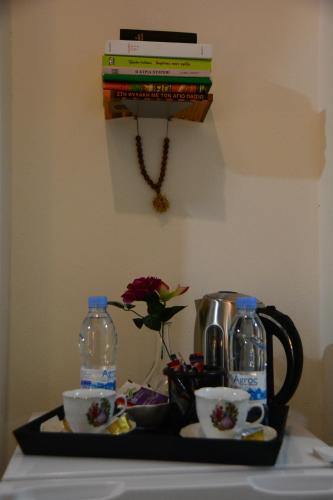 a tray with a tea pot and a coffee maker and books at Lazaros Stonehouse in Pano Lefkara