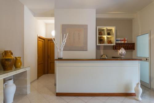 a kitchen with a counter with vases on it at Piccolo Hotel Villa Rosa in Ostuni