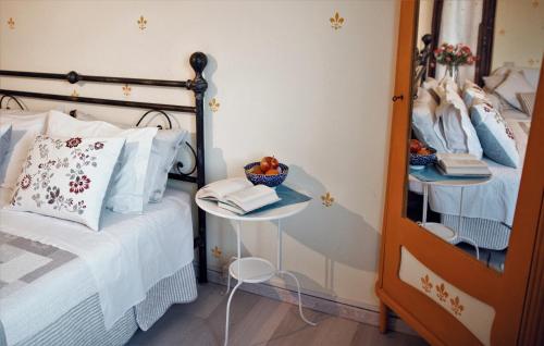 a bedroom with a bed and a table with a bowl of fruit at B&B Cascina Ciapilau in Asti