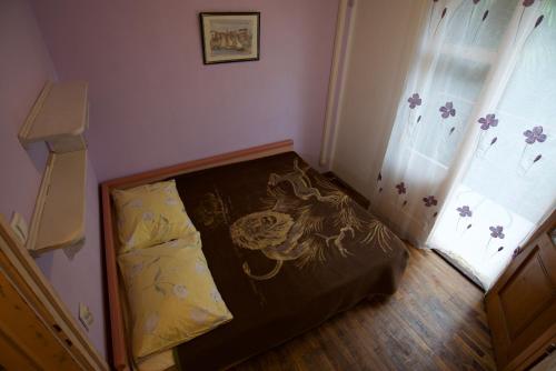 a small bedroom with a bed and a window at Romantic room with balcony in Lovran