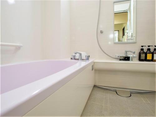 a white bathroom with a sink and a mirror at SHIN YOKOHAMA SK HOTEL - Non Smoking - Vacation STAY 86111 in Yokohama