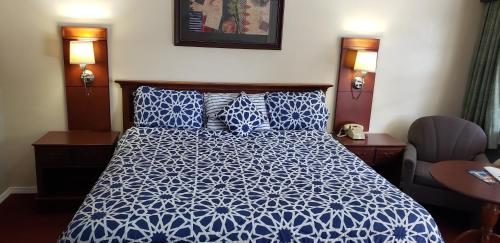 a blue and white bed in a hotel room at Swiss Village Inn in Eureka Springs