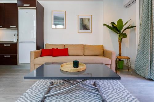 a living room with a couch and a coffee table at Atico de los FRANCESES by Cadiz4Rentals in Cádiz