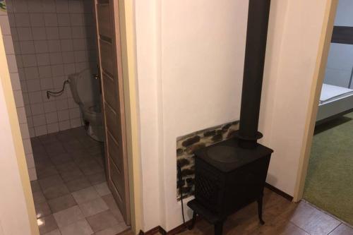 a bathroom with a stove in a room with a toilet at Bývanie s výhľadom v lokalite Detva in Detva