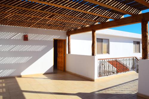a patio with a wooden pergola in a house at Hotel Santa Fe Loreto by Villa Group in Loreto