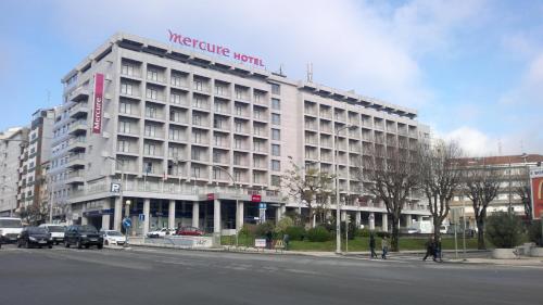 a large building with a large clock on the side of it at Hotel Mercure Braga Centro in Braga