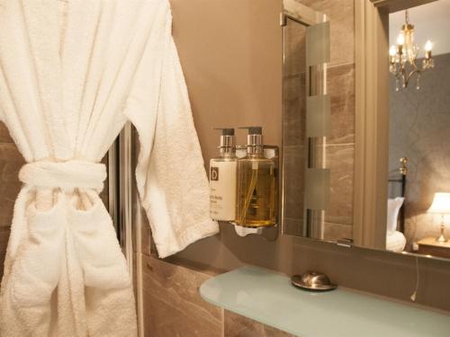a bathroom with a white towel and a mirror at The Poplars in Thirsk