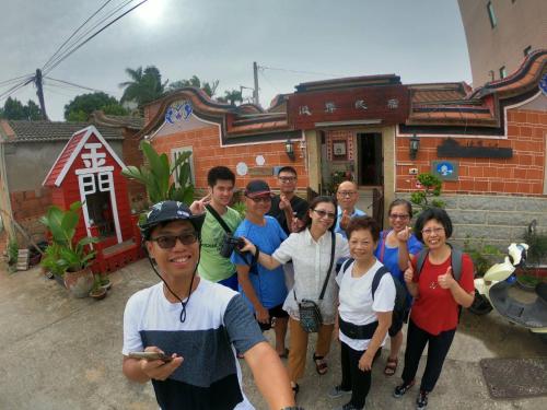 a group of people standing in front of a house at 彼岸古厝民宿-包棟優先--Biiann B&B in Jinning