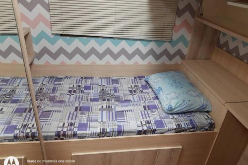 Etagenbett in einem kleinen Zimmer in einem Schlafzimmer in der Unterkunft Apartamento Térreo com Jardim e Garagem in Ponta Grossa