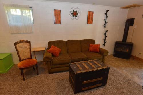a living room with a couch and a wood stove at The Park Chalet by Casago McCall - Donerightmanagement in McCall