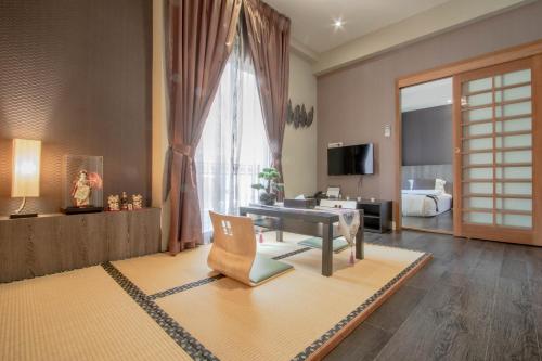a living room with a couch and a room with a bed at The Star of Sathorn in Bangkok