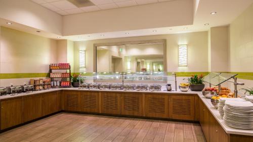 a restaurant with a counter with plates and dishes at Holiday Inn San Francisco - Golden Gateway newly renovated with No Resort Fee in San Francisco
