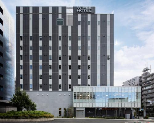 a building with a hotel sign on top of it at Wires Hotel Shinagawa Seaside in Tokyo