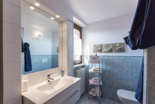 a bathroom with a sink and a toilet and a mirror at B&B Cascina Ciapilau in Asti