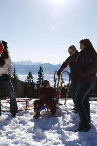 a group of people playing in the snow at Pension Paßler in Seeboden