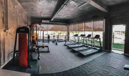 a gym with a bunch of treadmills and machines at Dungun Escapade Resort in Dungun