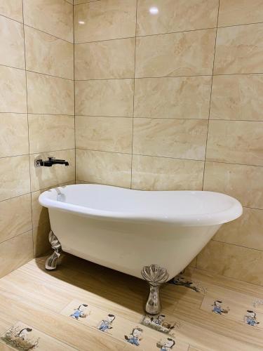 a white bath tub sitting in a bathroom at Taichung EnrichLife Hotel in Taichung