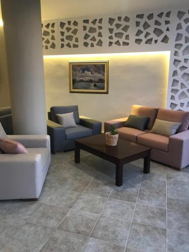 a living room with couches and a coffee table at MASSOURI BEACH HOTEL in Masouri
