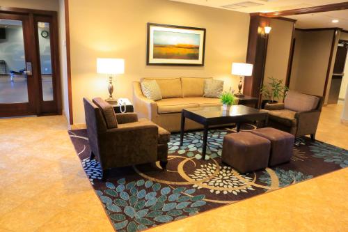 a lobby with a couch and chairs and a table at Staybridge Suites Silicon Valley - Milpitas by IHG in Milpitas