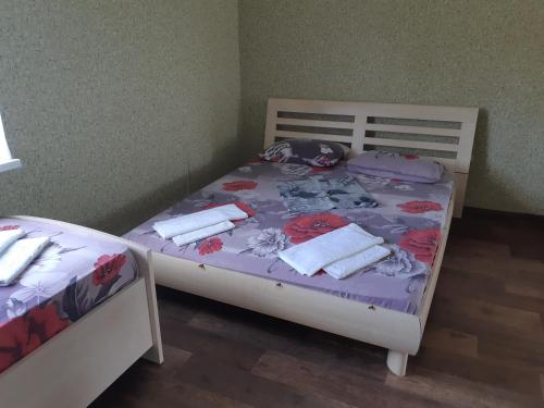 a bedroom with two beds with towels on them at Отель Маленький Рай in Zatoka