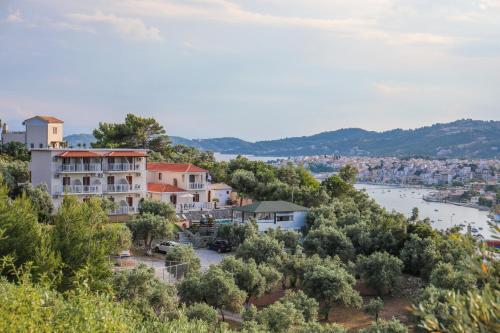 a building on a hill with a river and trees at Takis Studios in Punta