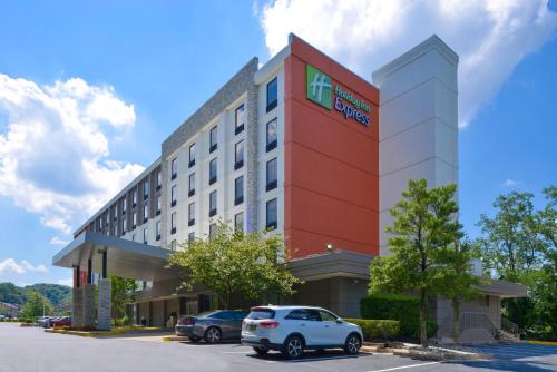 a hotel with cars parked in a parking lot at Holiday Inn Express Towson- Baltimore North by IHG in Towson