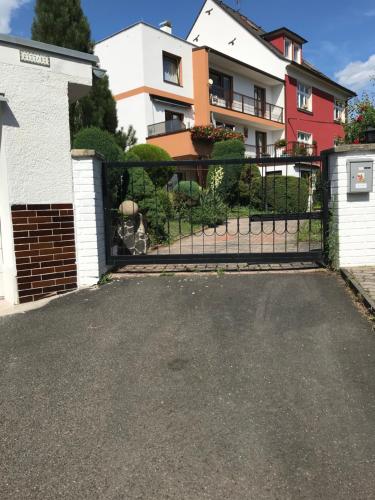 a driveway in front of a house with a gate at Vila Adéla - Teplice in Teplice
