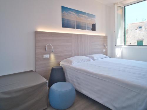 a bedroom with a large bed and a window at Hotel Medusa in Finale Ligure