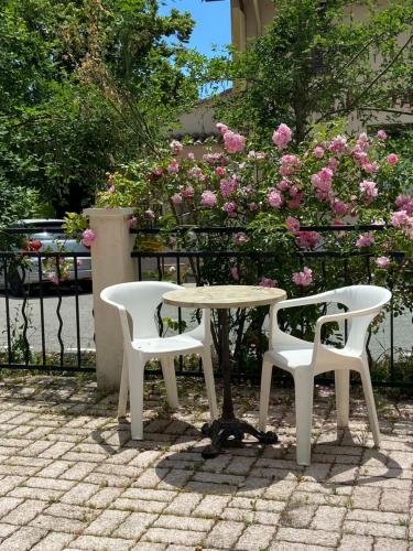 two chairs and a table and a table and two chairs at Les Merisiers B&B - Thorenc in Thorenc