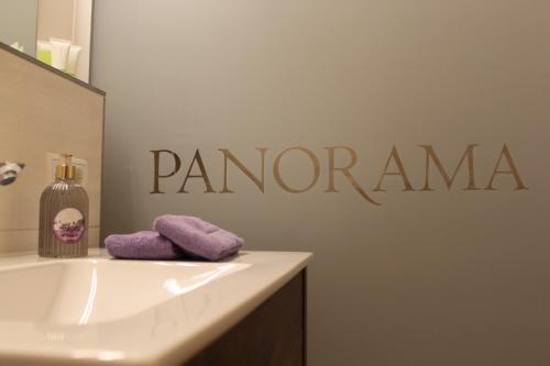 a bathroom with a sink and a sign that says panoramic at Apartment Panorama in Wagrain